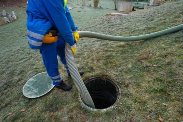 Emptying household septic tank. Cleaning sludge from septic system.