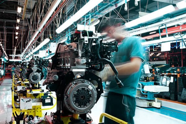 workman manufacturing in a car factory