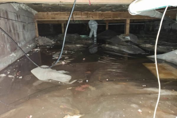 A crawl space filled with water after a pipe break.